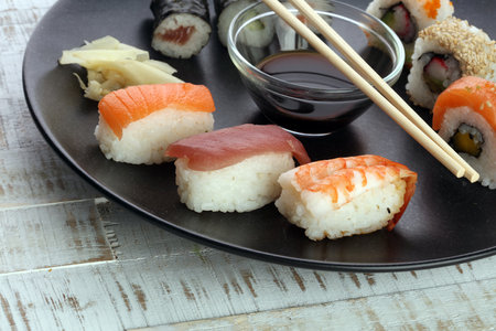 close up of sashimi sushi set with chopsticks and soy - sushi roll with salmon and sushi roll with smoked eel, selective focus.の写真素材