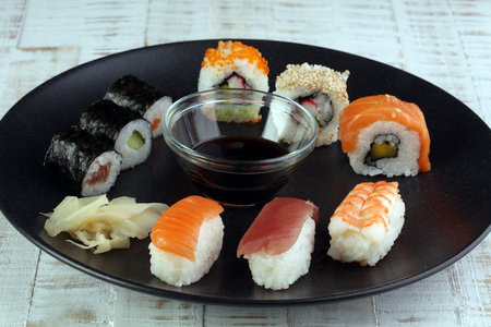 close up of sashimi sushi set with chopsticks and soy - sushi roll with salmon and sushi roll with smoked eel, selective focus.の写真素材