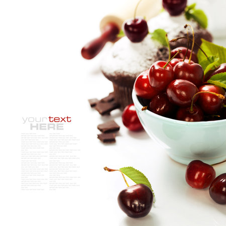 Cupcake with cherries and chocolate on white background with sample textの写真素材