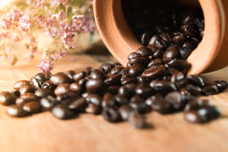 Coffee beans in a cup on wooden background. Selective focus.の写真素材