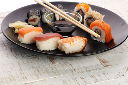 close up of sashimi sushi set with chopsticks and soy - sushi roll with salmon and sushi roll with smoked eel, selective focus.の写真素材