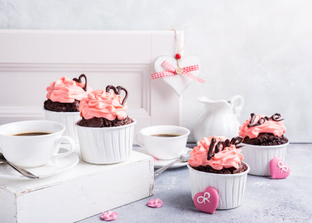 Valentines and Mother Day, wedding greeting card with beautiful chocolate cupcake, pink cream and heart on gray stone background with copy space.の写真素材
