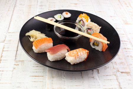 close up of sashimi sushi set with chopsticks and soy - sushi roll with salmon and sushi roll with smoked eel, selective focus.の写真素材
