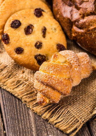Assortment of baked bread on wooden table backgroundの写真素材