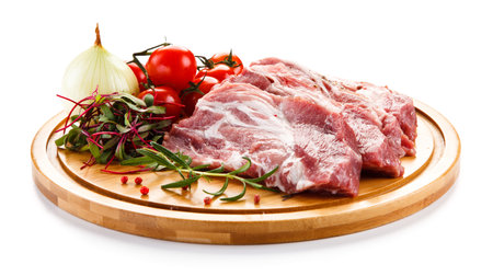 Raw pork ribs with herbs and spices on wooden board isolated on white backgroundの写真素材