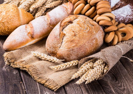 assortment of baked bread on wood tableの写真素材