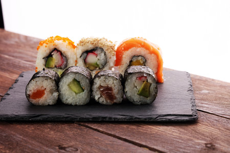 close up of sashimi sushi set with chopsticks and soy - sushi roll with salmon and sushi roll with smoked eel, selective focus.の写真素材