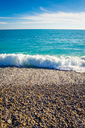 beautiful pebble beach and turquoise sea in summerの写真素材