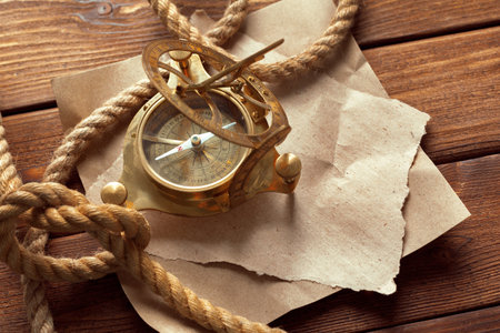 Compass and rope on wooden table. close upの写真素材