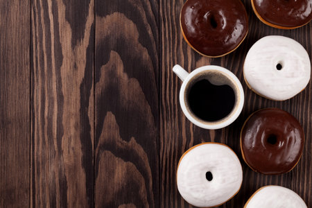Donuts and coffee on wooden table. Top view with copy spaceの写真素材