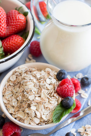 Healthy breakfast with oatmeal, berries and milk. Selective focus.