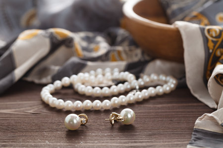 Womans morning scene with pearl lay on silk shawlの写真素材