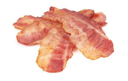cooked slices of bacon isolated on whiteの写真素材