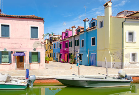Traditional brightly painted houses and canals on the italian island of Burano near Veniceの写真素材