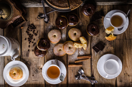 Old style donuts with sugar and dark chocolate, whole table, place for your advertisingの写真素材
