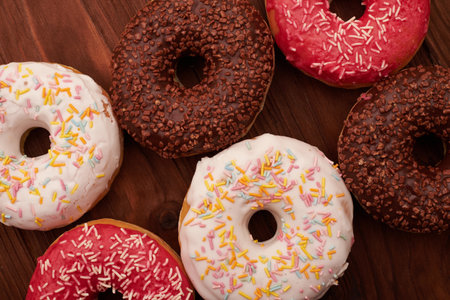close-up photo of glazed donuts on wood backgroundの写真素材