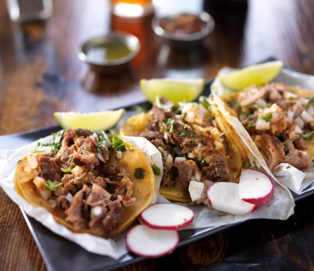 mexican tacos with limes and radish slicesの写真素材