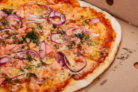 Delicious pizza with salmon and onionの写真素材