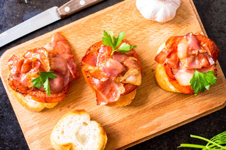Tapas with fried bacon, tomato and spicesの写真素材