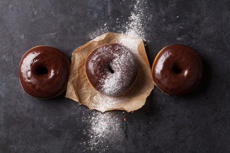 Colorful donuts on stone table. Top viewの写真素材