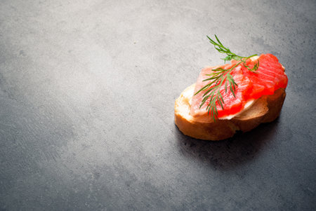 Sandwich with wheat bread with butter, salmon and herbs.の写真素材