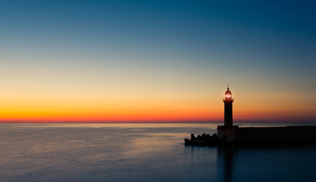Lighthouse in the middle of the sea at sunset. Tuscany, Italyの写真素材