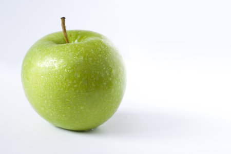 Close-up of green beautiful apple isolated on shadow backroundの写真素材