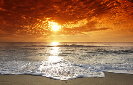 Beautiful sunset over the sea. The sun is reflected in the water.の写真素材