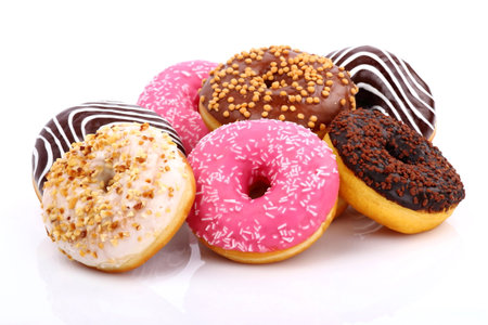 assorted donuts with chocolate frosted, pink glazed and sprinkles donuts.の写真素材