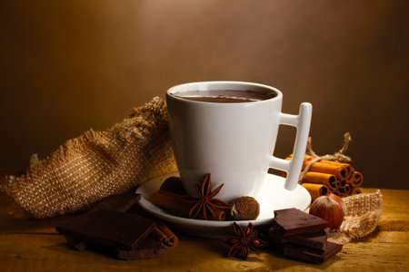cup of hot chocolate on wooden table on brown background, closeupの写真素材