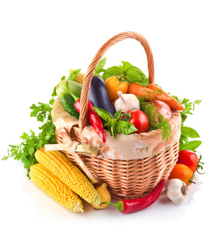 Fresh vegetables in wicker basket. Isolated on a white background.の写真素材