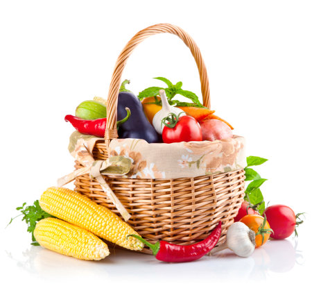 Fresh vegetables in a basket isolated on white background. Healthy food.の写真素材
