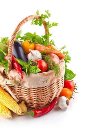 Fresh vegetables in a wicker basket isolated on a white background.の写真素材