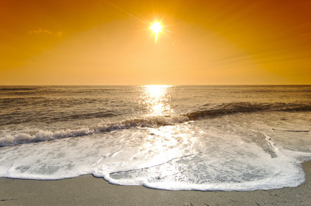 beautiful sunset on the beach, the sun sets over the seaの写真素材