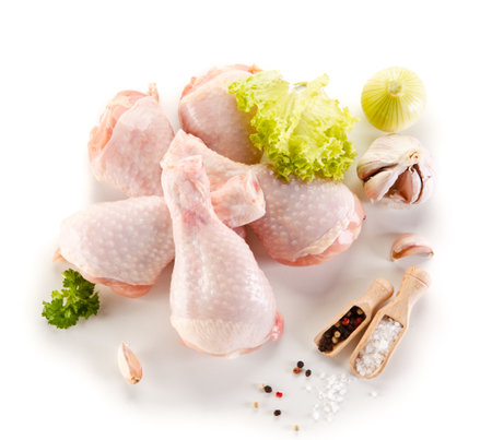 Raw chicken legs with herbs and spices isolated on white background. Top view.の写真素材