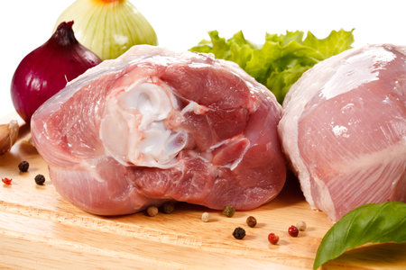 Raw chicken meat on cutting board. Isolated on a white background.の写真素材