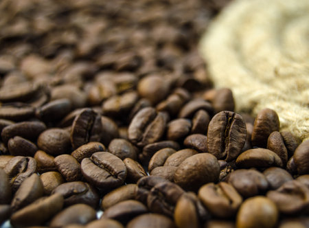 Coffee beans on sackcloth background. Selective focus.の写真素材