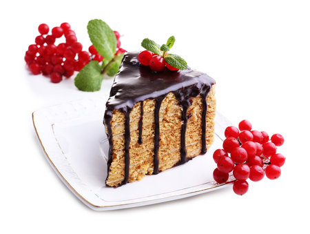 Piece of cake with chocolate glaze and berries, isolated on whiteの写真素材