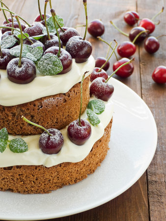 Cake with sweet cherries and whipped sour cream. Shallow dof.の写真素材