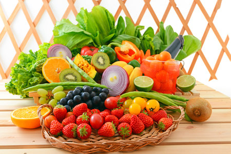 Fresh fruits and vegetables in a basket on a wooden table. Healthy food.の写真素材