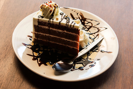 Chocolate cake with ice cream on wooden table. Selective focus.の写真素材