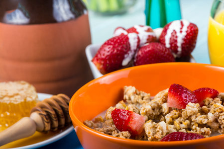 Healthy breakfast with muesli, honey and strawberries. Selective focus.の写真素材