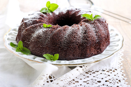 Chocolate bundt cake with mint leaves on a plate, selective focusの写真素材