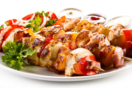 Grilled chicken kebabs with vegetables and sauce. Shallow dof.の写真素材
