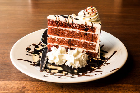 Chocolate cake with whipped cream in white plate - Vintage Light Filterの写真素材
