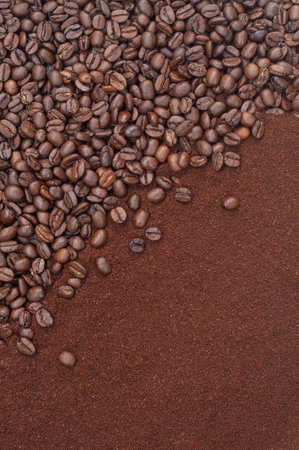Coffee beans and ground coffee on brown background. Top view.の写真素材