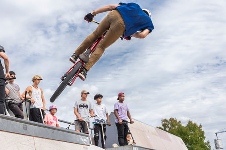 Unidentified BMX rider jumps on a ramp at a local skate park.