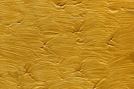 golden painted wall close up texture background, gold paint on wallのeditorial素材