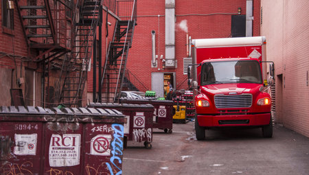 Trucks in the parking lot of a brick building in New York City