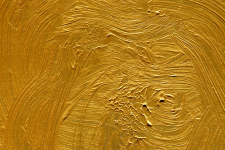 Gold paint on a wall as a background, closeup of photo